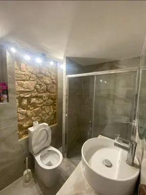 a bathroom with a toilet and a sink and a shower at Athens Apartment IV in Athens