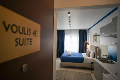 a bedroom with a bed and a sink in it at Plaka Voulis 45 by Zeus Suites in Athens