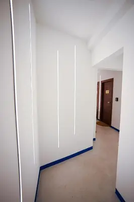 an empty hallway with white walls and blue trim at Plaka Voulis 45 by Zeus Suites in Athens