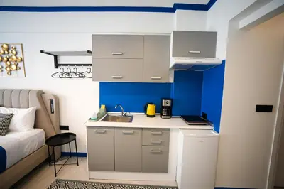 a small kitchen with a sink and a couch at Plaka Voulis 45 by Zeus Suites in Athens