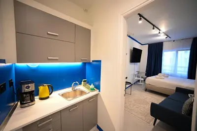 a kitchen with a sink and a room with a bed at Syntagma Center Suite by Zeus Suites in Athens