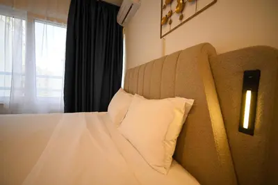 a bedroom with a bed with a pillow and a window at Syntagma Center Suite by Zeus Suites in Athens