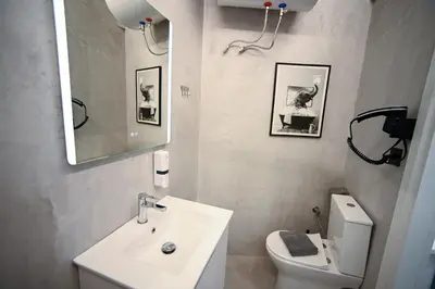 a bathroom with a sink and a toilet and a mirror at Syntagma Center Suite by Zeus Suites in Athens