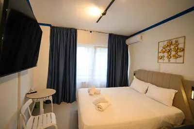 a bedroom with a bed and a table and a window at Syntagma Center Suite by Zeus Suites in Athens