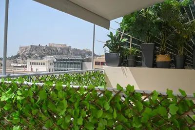 a balcony with plants on the roof of a building at Acropolis view family big veranda by Zeussuites in Athens