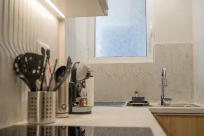 a kitchen counter with a sink with utensils at Mets-Athenian Horizon Escape in Athens