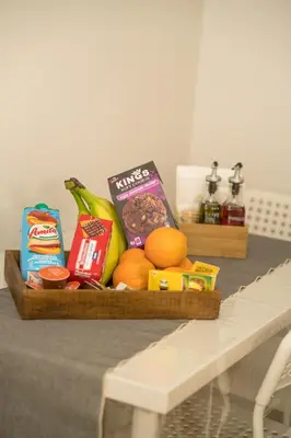 a basket of food and other foods on a table at Mets-Athenian Horizon Escape in Athens