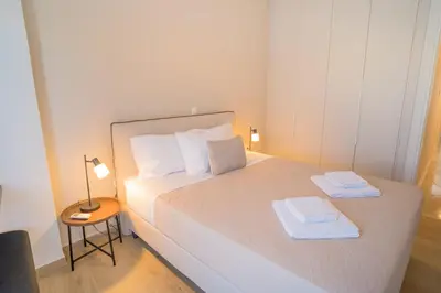 a small bedroom with a bed with two towels on it at Mets-Athenian Horizon Escape in Athens