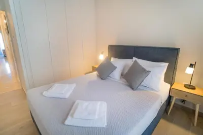 a bedroom with a bed with two towels on it at Mets-Athenian Horizon Escape in Athens