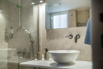 a bathroom with a sink and a shower at Mets-Athenian Horizon Escape in Athens