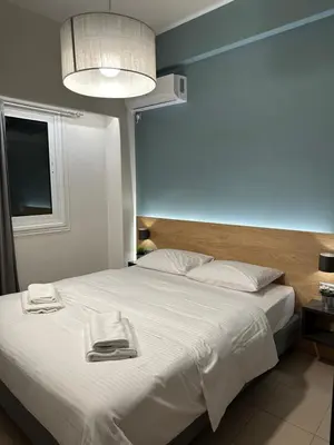 a bedroom with a large bed with two towels on it at Urban Muse V - Archaeological Museum of Athens in Athens