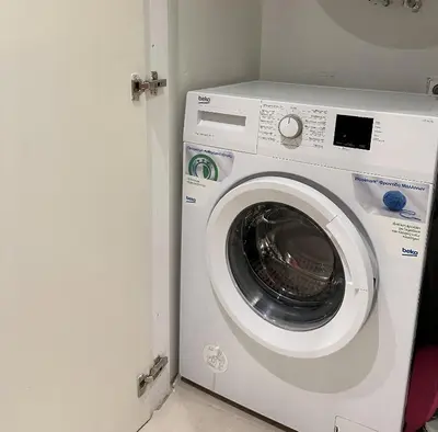 a washing machine in a room with a door at Urban Muse V - Archaeological Museum of Athens in Athens