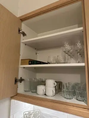 a cupboard filled with glasses and wine glasses at Urban Muse V - Archaeological Museum of Athens in Athens
