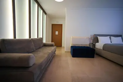 a living room with a couch and a bed at Tsakalof 10 Kolonaki by Zeus Suites in Athens