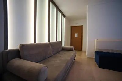 a living room with a brown couch in a room at Tsakalof 10 Kolonaki by Zeus Suites in Athens
