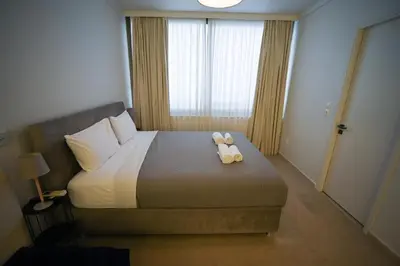a bedroom with a bed with two stuffed animals on it at Tsakalof 10 Kolonaki by Zeus Suites in Athens