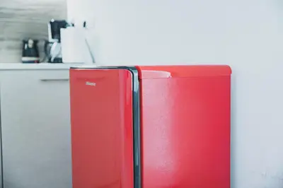 a red refrigerator in a kitchen next to a counter at Tsakalof 10 Kolonaki by Zeus Suites in Athens