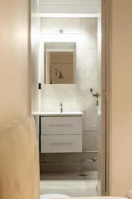 a bathroom with a sink and a mirror at Tsakalof 10A Elegant Studio by Zeus Suites in Athens
