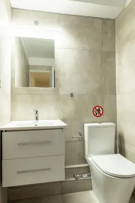a bathroom with a toilet and a sink and a mirror at Tsakalof 10A Elegant Studio by Zeus Suites in Athens
