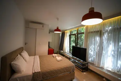 a bedroom with a bed and a flat screen tv at Tsakalof 10A Elegant Studio by Zeus Suites in Athens