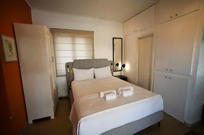 a bedroom with a bed with two towels on it at Tsakalof 10 Veranda Kolonaki by Zeussuites in Athens
