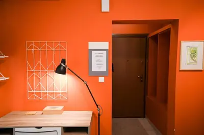 an orange room with a desk and a lamp at Tsakalof 10 Veranda Kolonaki by Zeussuites in Athens