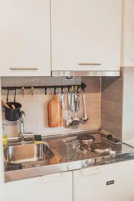 a kitchen with a sink and a stove at Tsakalof 10 Veranda Kolonaki by Zeussuites in Athens