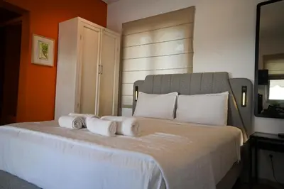 a bedroom with a large bed with white pillows at Tsakalof 10 Veranda Kolonaki by Zeussuites in Athens