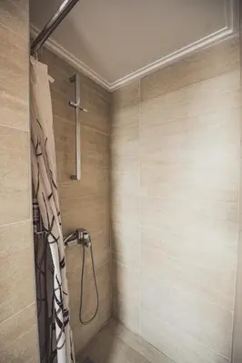 a bathroom with a shower with a cross on the wall at Tsakalof 10 Veranda in Athens