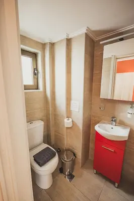 a bathroom with a white toilet and a sink at Tsakalof 10 Veranda in Athens