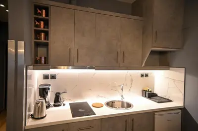 a kitchen counter with a mixer and a sink at Monastiraki Athens Luxe Suite by Zeus Suites in Athens