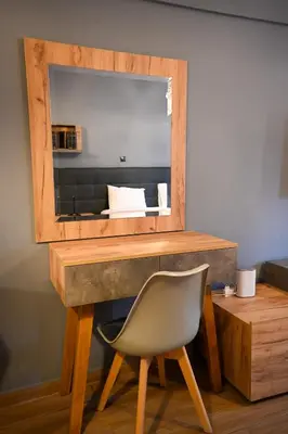 a desk with a chair in front of a mirror at Monastiraki Athens Luxe Suite by Zeus Suites in Athens
