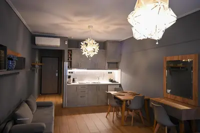 a kitchen and dining room with a table and chairs at Monastiraki Athens Luxe Suite by Zeus Suites in Athens