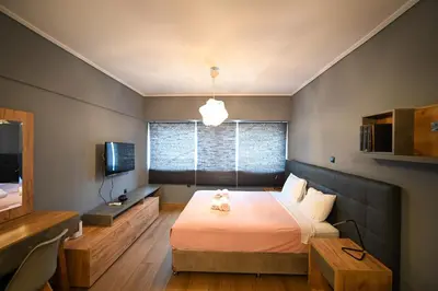 a bedroom with a large bed and a television at Monastiraki Athens Luxe Suite by Zeus Suites in Athens