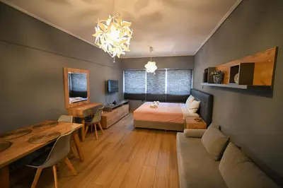 a bedroom with a bed and a dining table at Monastiraki Athens Luxe Suite by Zeus Suites in Athens