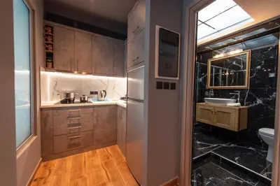 a small kitchen with a sink and a refrigerator at Acropolis Majestic View Residence Aiolou 97 by Zeussuites in Athens