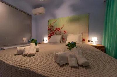 a bedroom with a large bed with towels on it at Acropolis Majestic View Residence Aiolou 97 by Zeussuites in Athens