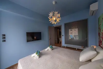 a blue bedroom with two toy animals on a bed at Acropolis Majestic View Residence Aiolou 97 by Zeussuites in Athens