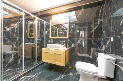 a bathroom with a toilet and a sink and a mirror at Acropolis Majestic View Residence Aiolou 97 by Zeussuites in Athens
