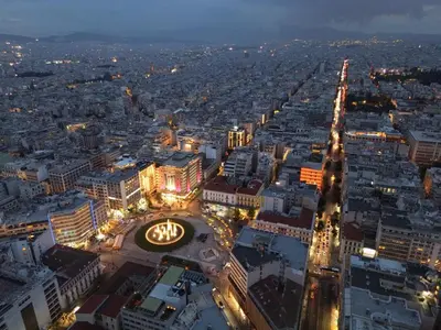 an aerial view of a city at night at Acropolis Majestic View Residence Aiolou 97 by Zeussuites in Athens