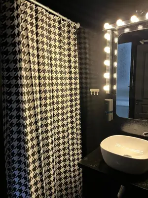 a bathroom with a sink and a mirror at Tsakalof 17 Black in Athens