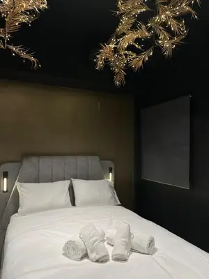 a bedroom with a bed with two towels on it at Tsakalof 17 Black in Athens