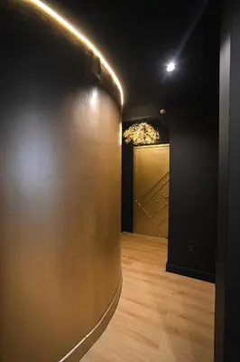 a dark room with a door and a wooden floor at Tsakalof 17 Black Suite by Zeus Suites in Athens
