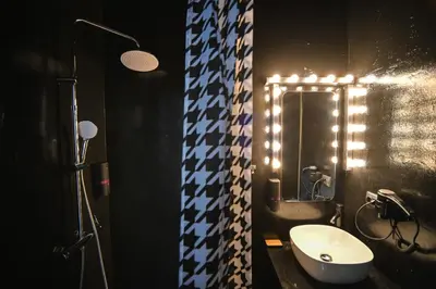 a bathroom with a toilet and a sink and a mirror at Tsakalof 17 Black Suite by Zeus Suites in Athens