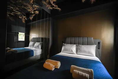 a bedroom with a bed with two orange towels on it at Tsakalof 17 Black Suite by Zeus Suites in Athens
