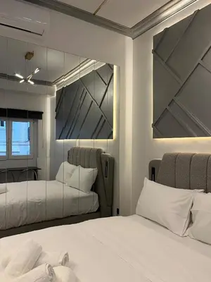 a bedroom with two beds and a mirror at Urban Diamond in Athens