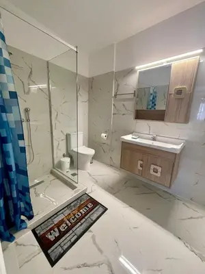 a bathroom with a shower and a toilet and a sink at Ivory Escape Apartment - ATH Airport in Spáta