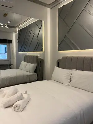 a bedroom with a bed with towels on it at Fos Diamond Suite by Zeus Suites in Athens