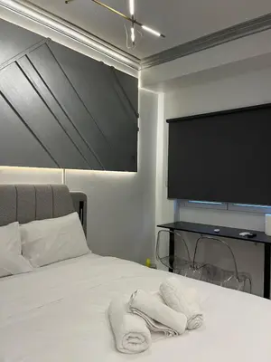 a bedroom with a bed with a flat screen tv at Fos Diamond Suite by Zeus Suites in Athens