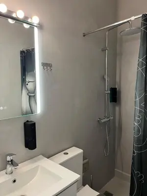 a bathroom with a sink and a shower with a mirror at Fos Diamond Suite by Zeus Suites in Athens